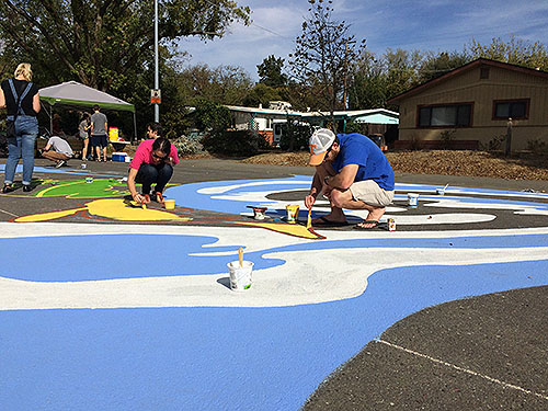 painting a yellow fish that emerges from the stream